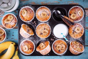 chocolate chips banana muffins on rustic background